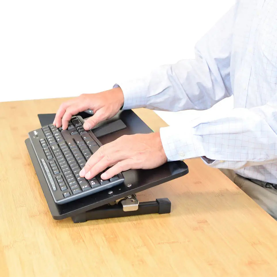 Improve wrist and arm alignment with a standing desk keyboard stand.